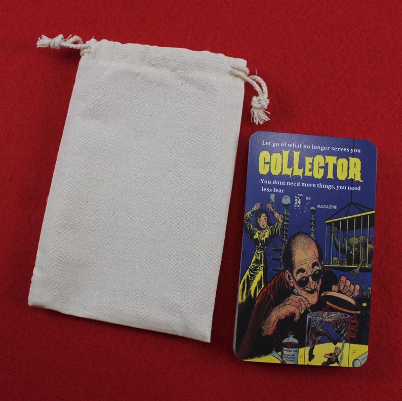 May include: A cream-colored drawstring bag next to a rectangular card with the word "COLLECTOR" in yellow and blue. The card has an illustration of a man and woman, with text that reads "Let go of what no longer serves you."