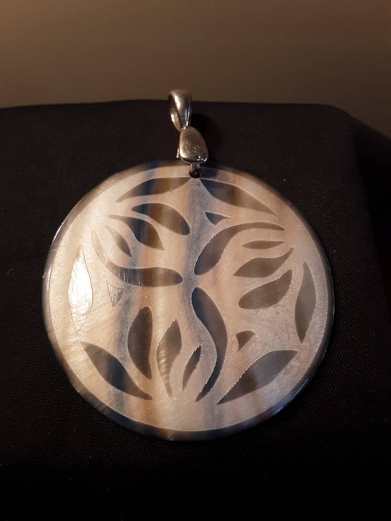 Vintage Mother of Pearl carved shell disk pendant.