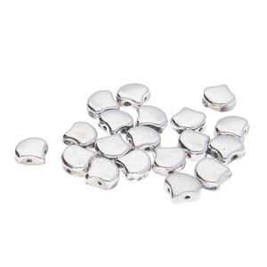 May include: A group of silver-colored, teardrop-shaped beads with a hole at the top. The beads are scattered on a white background.