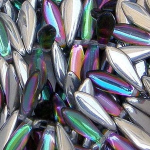 May include: A close-up of iridescent glass beads in a teardrop shape. The beads have a silver, green, purple, and blue iridescent finish.