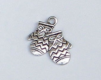 May include: Silver charm in the shape of two mittens with a chevron pattern. The mittens are joined together at the wrist.