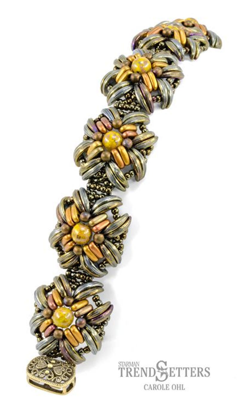 May include: A gold and silver beaded bracelet with a floral design. The bracelet has a clasp closure and is made with small, round beads. The bracelet is a statement piece and would be a great addition to any jewelry collection.