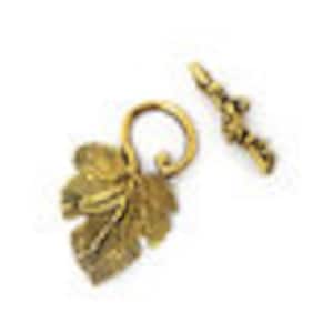 May include: Gold-toned metal toggle clasp with a leaf design. The clasp features a detailed leaf pendant and a bar with decorative accents. The leaf pendant is approximately 1 inch in length. The clasp is designed for jewelry making and crafts.