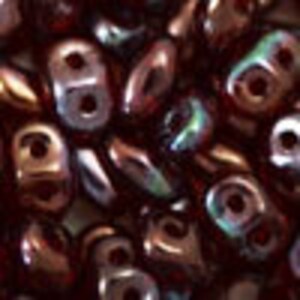 May include: Close-up of a collection of small, iridescent beads. The beads are a mix of brown, bronze, and hints of green and blue. Each bead has two holes, suggesting they are designed for stringing or weaving into jewelry or other crafts.