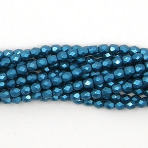 May include: Strands of faceted, teal-colored beads. The beads have a metallic sheen and a multi-faceted surface, reflecting light. The beads are strung together, forming a continuous line. Ideal for jewelry making.