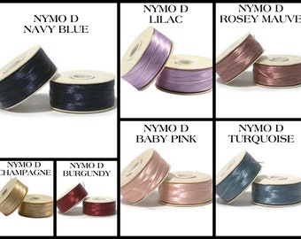 May include: Assortment of spools of Nymo D thread in various colours, including navy blue, lilac, rose mauve, champagne, burgundy, baby pink, and turquoise.