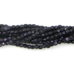 May include: A strand of dark purple faceted glass beads. The beads are small and have a shiny finish.