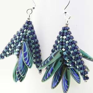 May include: A pair of dangle earrings with a teardrop shape. The earrings are made with blue and green iridescent glass beads and silver-toned metal.