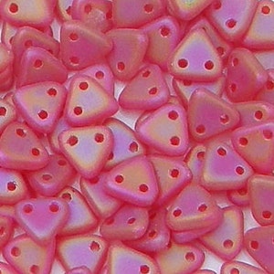 May include: A close-up of a pile of small, pink, iridescent triangle beads with three holes each.
