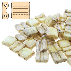 May include: A pile of small, square, off-white glass beads with a subtle iridescent sheen. The beads have a slightly wavy texture and are perfect for jewelry making.