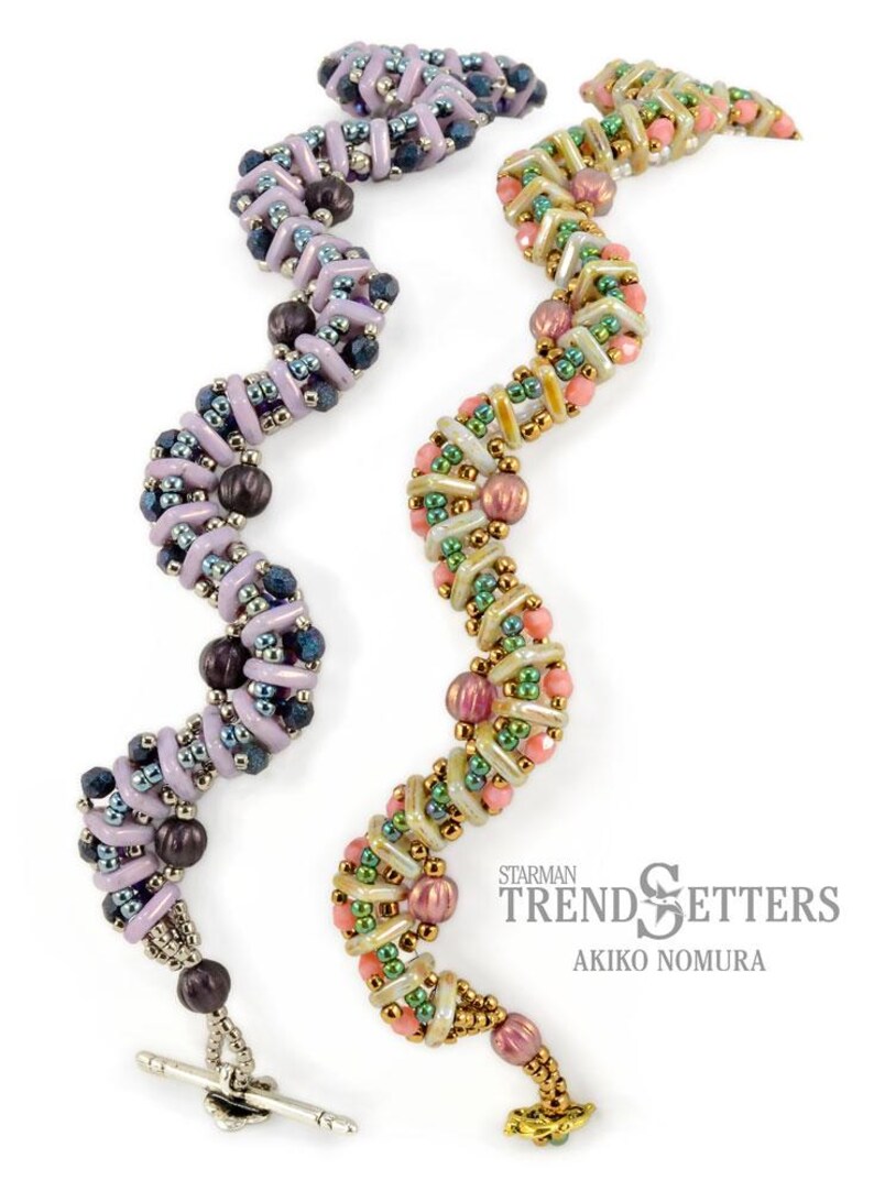 May include: Two beaded bracelets with a wavy design. The bracelet on the left is purple, blue, and silver. The bracelet on the right is pink, green, and gold. The bracelets are both made with small beads and have a toggle clasp. The text "Starman Trendsetters Akiko Nomura" is visible in the image.