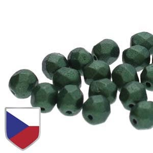 May include: A group of dark green faceted glass beads. The beads have a metallic sheen and are scattered on a white surface.
