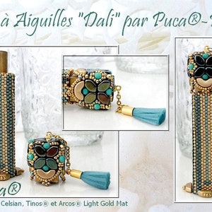 May include: A needle case with a beaded design in shades of green, gold, and turquoise. The case has a tassel and a small chain. The text "Etui à Aiguilles "Dali" par Puca®-Paris" is visible at the top of the image. The text "Puca®" is visible at the bottom of the image. The text "Paros® Full Celsian, Tinos® et Arcos® Light Gold Mat" is visible at the bottom of the image.
