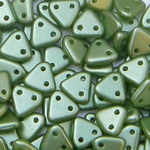 May include: A pile of green triangle-shaped beads with two holes each. The beads have a metallic sheen.