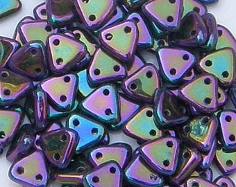 May include: A pile of iridescent triangle-shaped beads. Each bead has three holes and a metallic finish that shifts between purple, green, and blue. These beads are suitable for jewelry making and other craft projects.