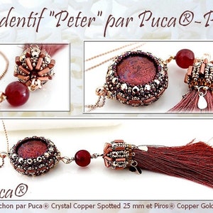May include: A pendant necklace with the text "Pendentif Peter par Puca®-Paris". The necklace features a round, reddish-brown cabochon, beaded accents, and a tassel. The pendant is connected to a delicate chain.
