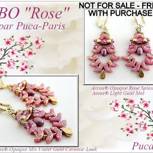 May include: A pair of pink and gold earrings with a floral design. The earrings are made with small beads and have a delicate, feminine look. The earrings are labeled "BO "Rose" par Puca-Paris" and "Arcos® Opaque Rose Splash Amos® Light Gold Mat Samos® Opaque Mix Violet Gold Ceramic Look".
