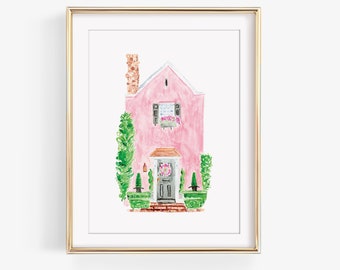 May include: A watercolor painting of a pink house with a green door and a wreath. The house has a white window with shutters and a green roof. There are green bushes on either side of the house.