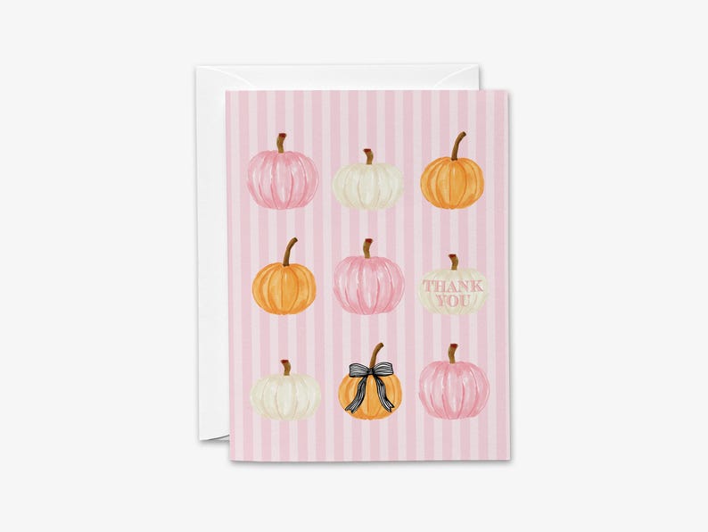 A pink striped card with nine pumpkins of various sizes and colors, including white, orange, and black bows, arranged in a grid pattern.