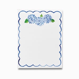 May include: A white notepad with a blue scalloped border and a watercolor illustration of blue hydrangeas at the top.