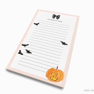 a lined paper pad with a pumpkin and bats design, and the text "ANABEL TIK" at the top.