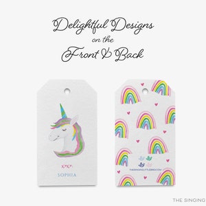 May include: Two gift tags with a unicorn and rainbow design. The front tag features a watercolor illustration of a unicorn with a rainbow mane and horn. The back tag features a repeating pattern of colorful rainbows with pink hearts.