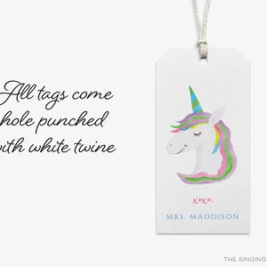May include: A white gift tag with a watercolor illustration of a unicorn with a rainbow mane and horn. The tag has the text "xoxo, MRS. MADDISON" and "THE SINGING LITTLE BIRD" at the bottom.