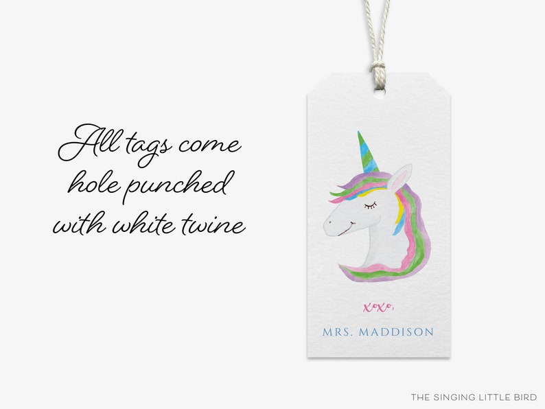 May include: A white gift tag with a watercolor illustration of a unicorn with a rainbow mane and horn. The tag has the text "xoxo, MRS. MADDISON" and "THE SINGING LITTLE BIRD" at the bottom.