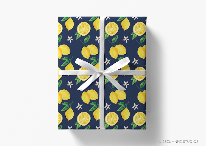 a present wrapped in a blue wrapping paper with lemons on it