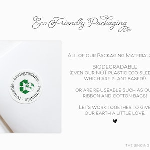 May include: A white background with green text that reads "Eco Friendly Packaging". Below the text is a white square with a green and white sticker that reads "biodegradable, reusable, recyclable". The text below the square reads "ALL OF OUR PACKAGING MATERIALS ARE BIODEGRADABLE (EVEN OUR NOT PLASTIC ECO-SLEEVES, WHICH ARE PLANT BASED!) OR ARE RE-USEABLE SUCH AS OUR RIBBON AND COTTON BAGS! LET'S WORK TOGETHER TO GIVE OUR EARTH A LITTLE LOVE. THE SINGING LITTLE BIRD"