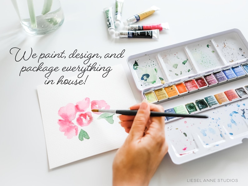 a person is painting with watercolors on a table