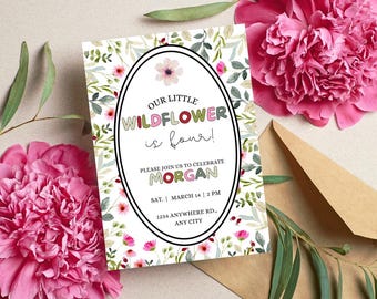 May include: A floral birthday invitation with the text "OUR LITTLE WILDFLOWER is four!" in a white oval frame. The invitation is surrounded by pink flowers and a brown envelope. The invitation includes the name "MORGAN" and event details.