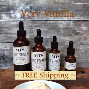 May include: Four amber glass bottles with droppers containing vanilla fragrance oil. The bottles are labeled "MTS Pure Premium Fragrance Oils" with different sizes: 4 oz, 2 oz, 1 oz, and 1/2 oz. The text "Very Vanilla" and "Free Shipping" is also visible.