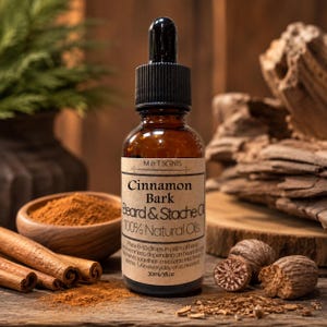 May include: A brown glass dropper bottle of M & T Scents Cinnamon Bark Beard & Stache Oil. The label features the text Cinnamon Bark, Beard & Stache Oil, 100% Natural Oils, and 30ml/1fl oz. The bottle has a black dropper cap and a tan paper label.