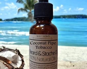 May include: A brown glass dropper bottle of M & T Scents Coconut Pipe Tobacco Beard & Stache Oil with 100% Natural Oils printed on the label. The bottle contains 30ml/1fl oz of product and features a black dropper cap and a tan paper label.
