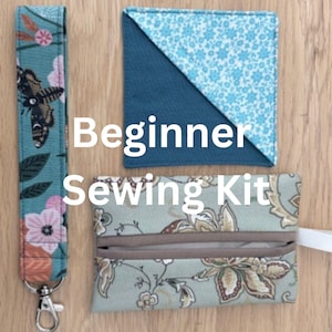 May include: A beginner sewing kit featuring a teal floral print wrist strap, a blue and floral print bookmark, and a floral print pouch. The text "Beginner Sewing Kit" is displayed in white.