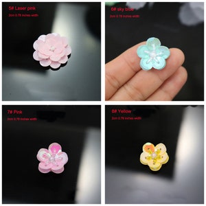 May include: Four flower-shaped sequin embellishments in laser pink, sky blue, pink, and yellow. Each piece measures 2 cm or 0.78 inches in width and features a central cluster of small beads surrounded by five rounded, iridescent sequin petals.