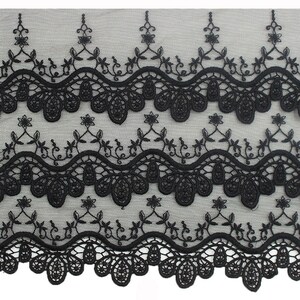 May include: Black lace trim with a scalloped edge and floral embroidery. The lace has a delicate, intricate design.