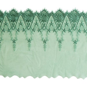 May include: Green lace trim with a scalloped edge and floral embroidery.