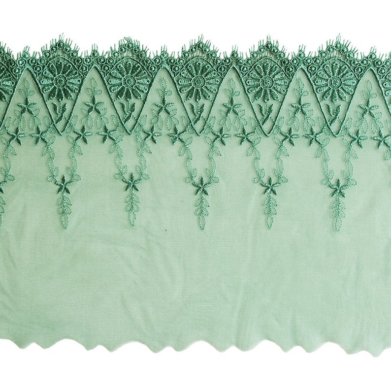 May include: Green lace trim with a scalloped edge and floral embroidery.