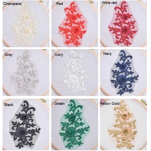 May include: Nine embroidered floral appliques in various colors, including champagne, red, wine red, gray, ivory, navy, black, green, and yellow gold. Each applique features a delicate floral design with intricate details.