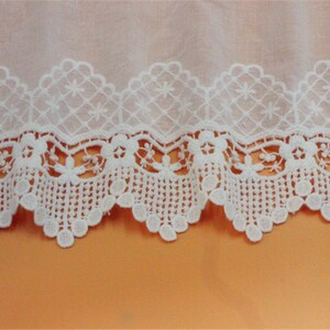 May include: White cotton lace trim with a scalloped edge and a delicate floral pattern.