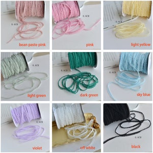 May include: Nine spools of lace trim in various colors, including bean paste pink, pink, light yellow, light green, dark green, sky blue, violet, off white, and black. Each spool is labeled with the width of the trim, 0.6 cm.