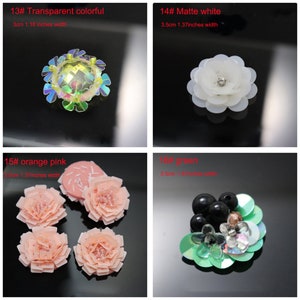 May include: A collection of four decorative floral embellishments. 13# is a transparent colorful flower, 3cm (1.18 inches) wide. 14# is a matte white flower, 3.5cm (1.37 inches) wide. 15# are orange-pink flowers, 3.5cm (1.37 inches) wide. 16# is a green floral cluster, 3.5cm (1.37 inches) wide.