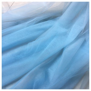 May include: A light blue tulle fabric with a soft, delicate texture.