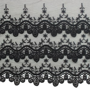 May include: Black lace trim with a scalloped edge and floral embroidery. The lace has a delicate, intricate design.