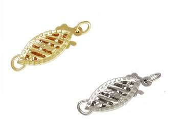 May include: Two leaf-shaped jewelry clasps, one gold-toned and one silver-toned, are displayed against a white background. Each clasp features a detailed, openwork design with a secure closure mechanism and small loops for attachment.