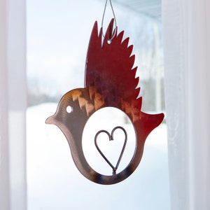 Hand forged wrought iron bird with heart cutout