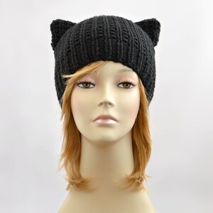 May include: Black knit beanie with cat ears. The beanie is made of a soft, warm yarn and is perfect for keeping your head and ears warm in the winter.