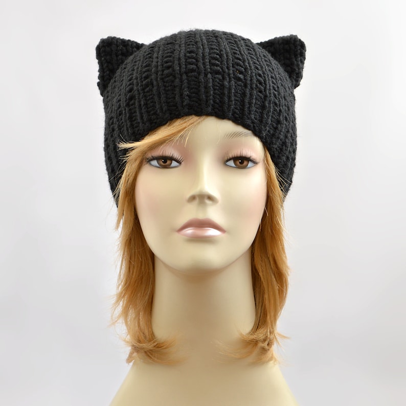 May include: Black knit beanie with cat ears. The beanie is made of a soft, warm yarn and is perfect for keeping your head and ears warm in the winter.